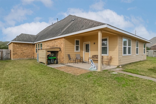 back of house featuring a lawn and a patio