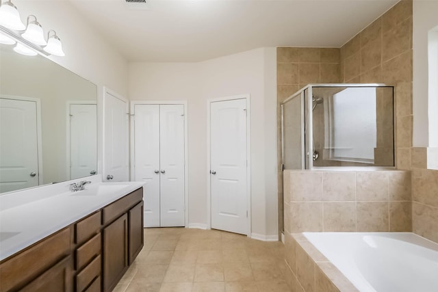 bathroom featuring vanity, shower with separate bathtub, and tile patterned flooring