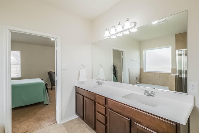 bathroom featuring tile patterned flooring, a bathing tub, and vanity