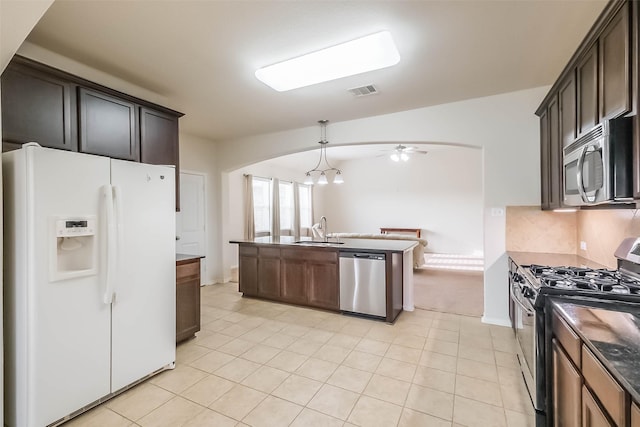 kitchen featuring dark brown cabinetry, sink, hanging light fixtures, ceiling fan, and stainless steel appliances