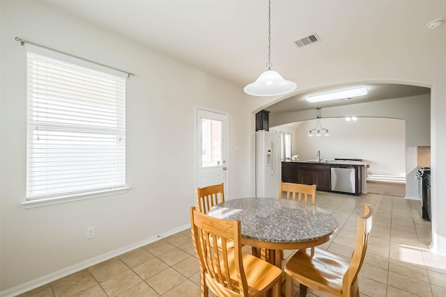 dining room featuring sink and light tile patterned floors