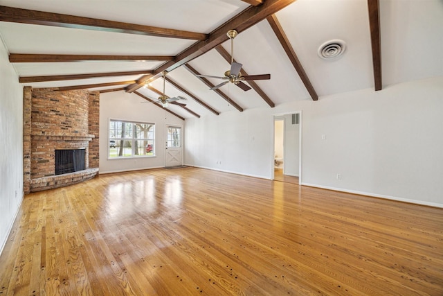 unfurnished living room with ceiling fan, light hardwood / wood-style floors, vaulted ceiling with beams, and a brick fireplace