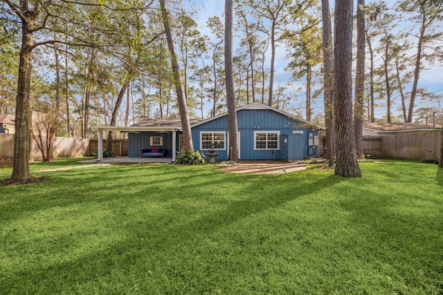 back of property with a lawn and a patio area