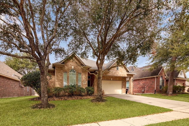 view of front of house featuring a garage and a front lawn