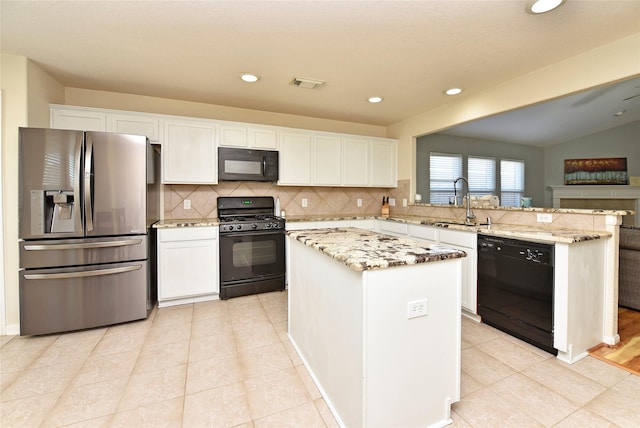 kitchen featuring white cabinetry, tasteful backsplash, a center island, kitchen peninsula, and black appliances