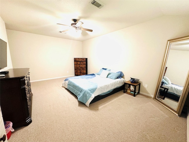 bedroom with ceiling fan, vaulted ceiling, and carpet