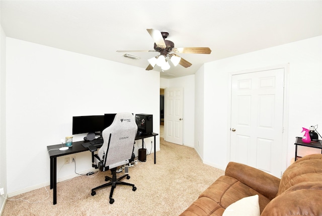 carpeted office space with ceiling fan