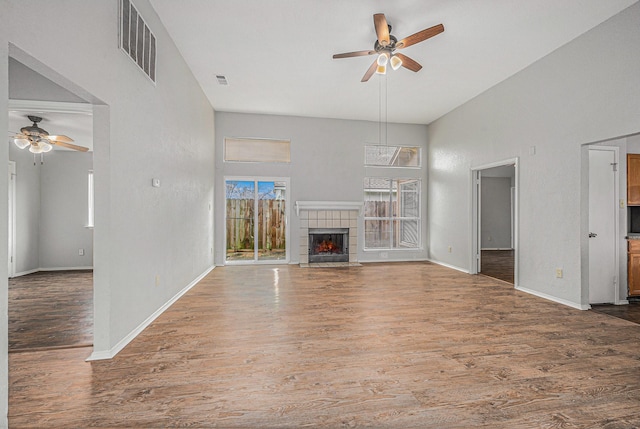 unfurnished living room featuring ceiling fan, hardwood / wood-style floors, and a fireplace