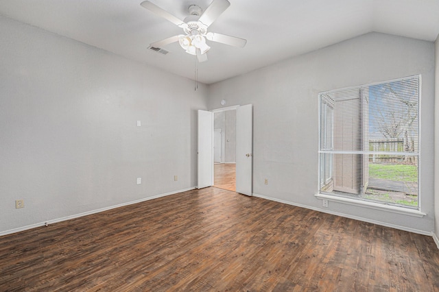 unfurnished room featuring dark hardwood / wood-style flooring, lofted ceiling, and ceiling fan