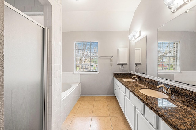 bathroom with tile patterned flooring, vanity, lofted ceiling, and plus walk in shower