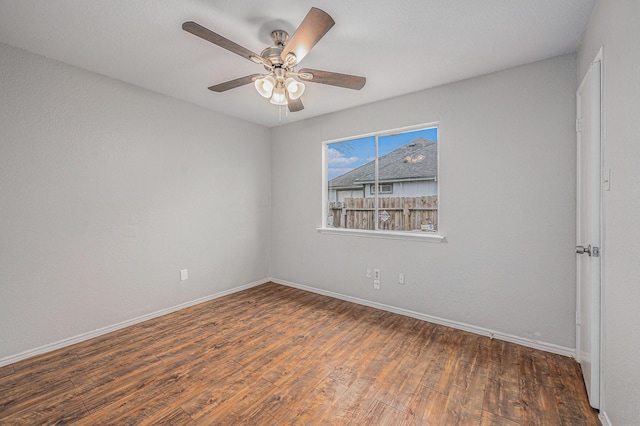 unfurnished room with dark hardwood / wood-style floors and ceiling fan