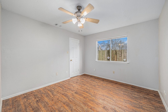 empty room with ceiling fan and dark hardwood / wood-style floors