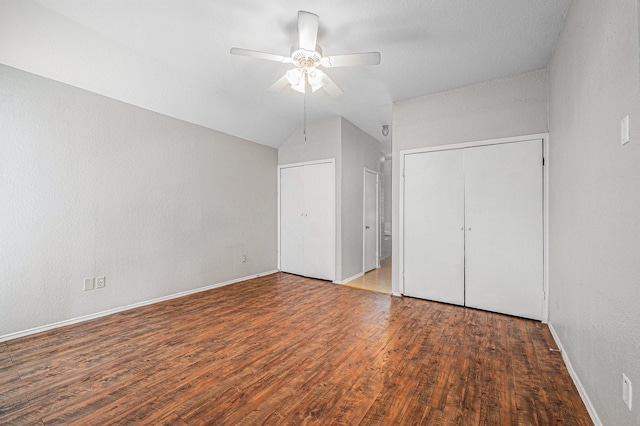 unfurnished bedroom with vaulted ceiling, ceiling fan, dark hardwood / wood-style flooring, and a closet