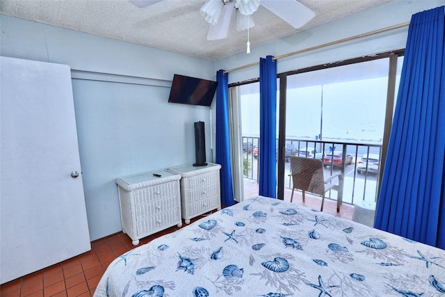 tiled bedroom featuring ceiling fan and a textured ceiling