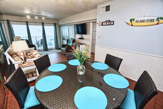 dining room featuring a textured ceiling