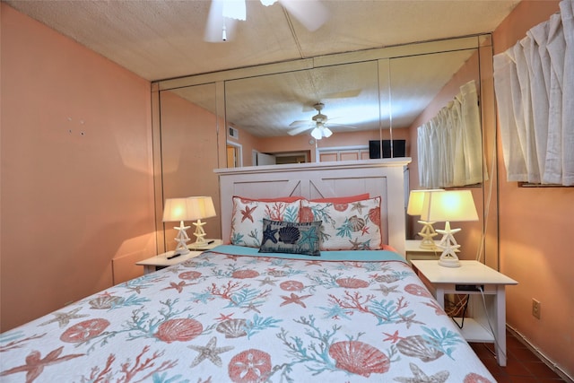 bedroom with ceiling fan and a textured ceiling