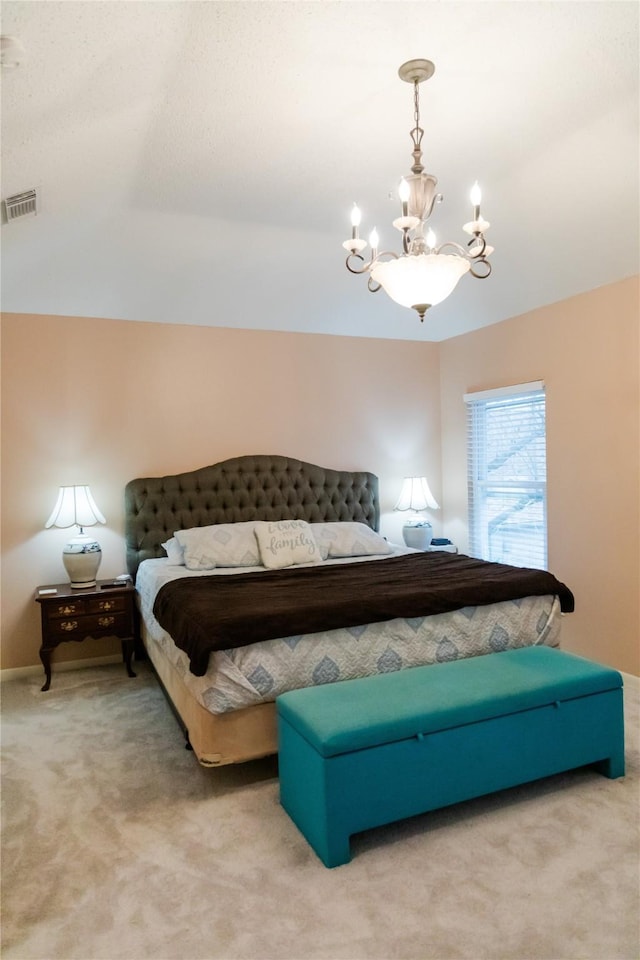 bedroom featuring carpet and a chandelier