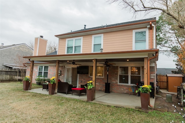 back of property with an outdoor living space, a lawn, a patio, and ceiling fan