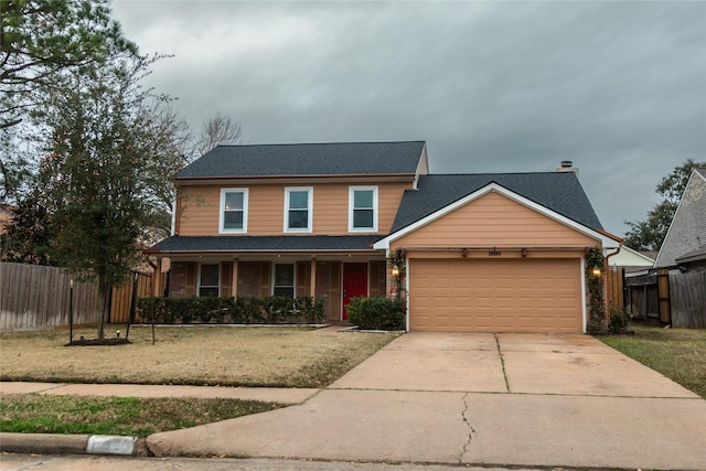 front facade with a garage and a front yard