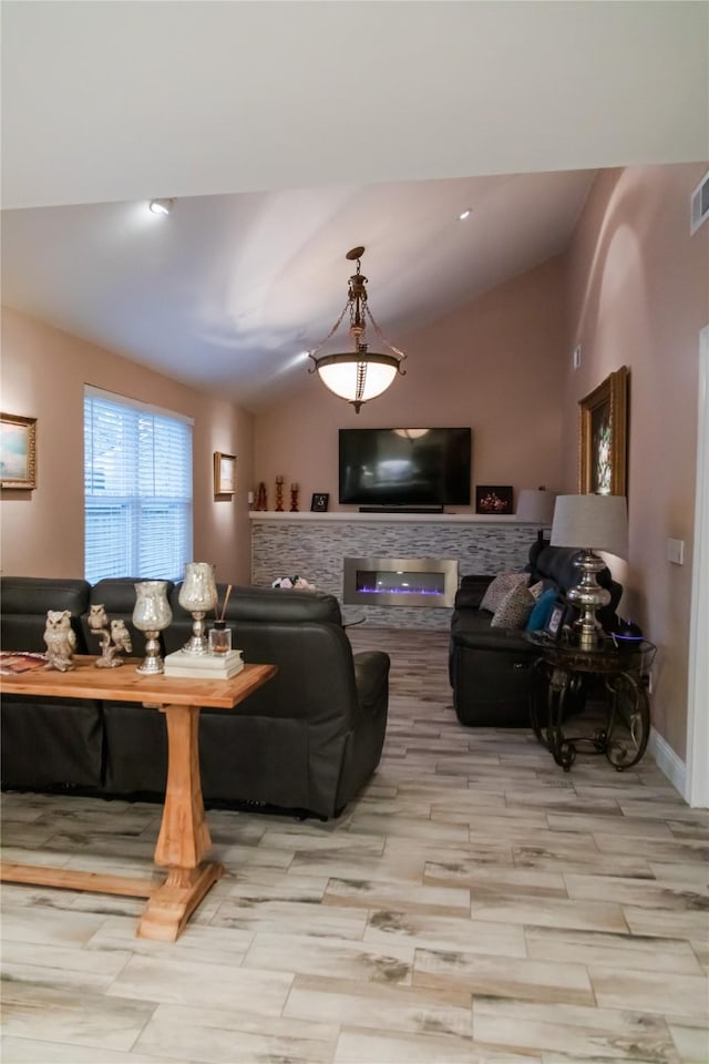 living room featuring lofted ceiling