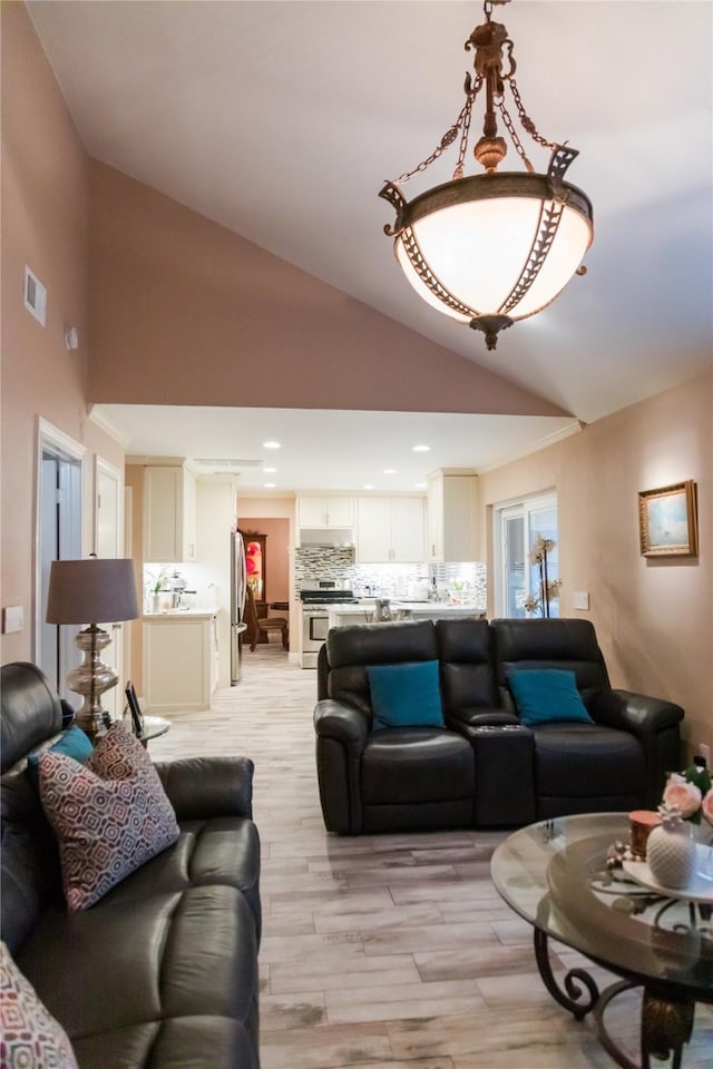 living room with lofted ceiling and light hardwood / wood-style floors