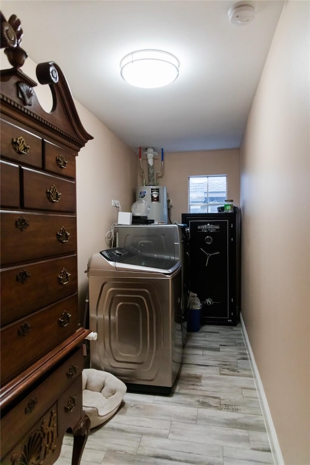 laundry room with independent washer and dryer and water heater