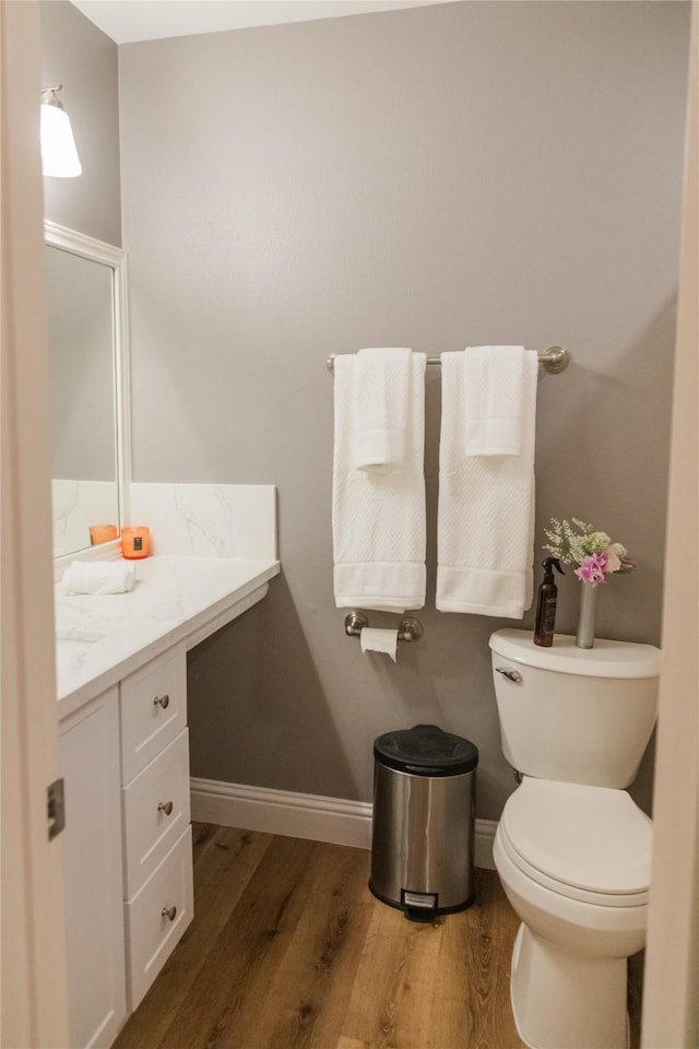 bathroom featuring hardwood / wood-style flooring, vanity, and toilet