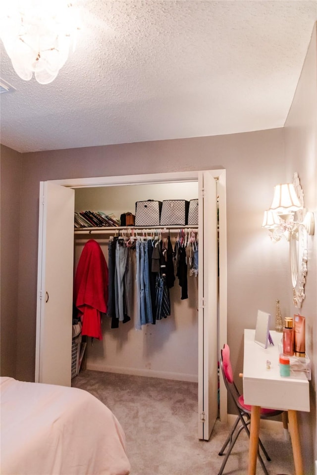 bedroom with a closet, a textured ceiling, and carpet flooring