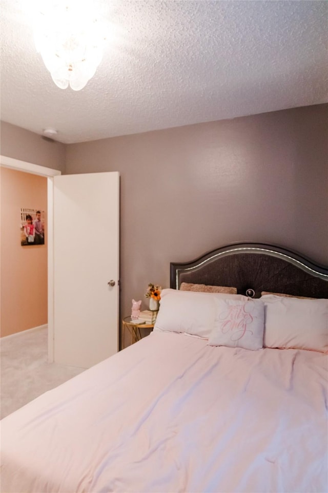 unfurnished bedroom with carpet and a textured ceiling