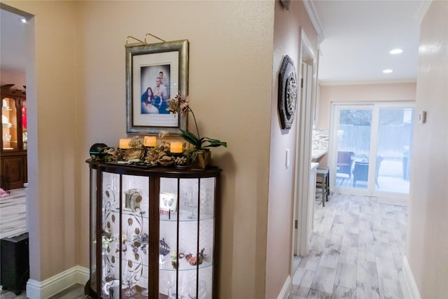 hall featuring crown molding and light wood-type flooring