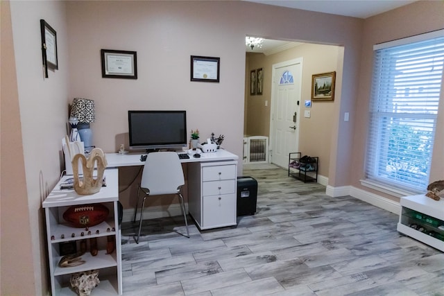 office space with a healthy amount of sunlight and light hardwood / wood-style flooring