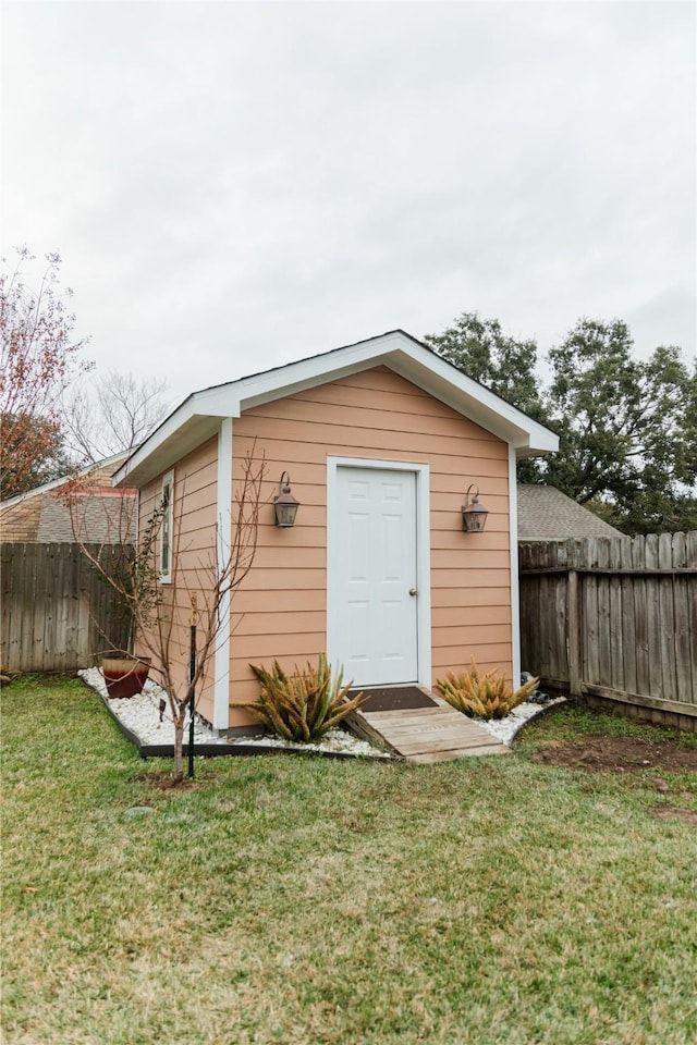 view of outbuilding with a lawn