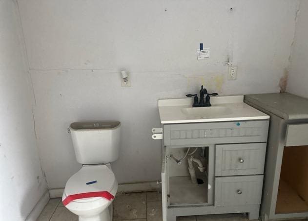 bathroom featuring vanity, toilet, and tile patterned flooring