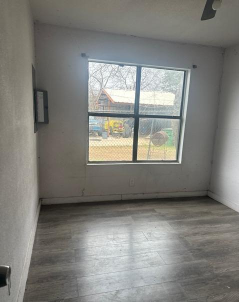 empty room featuring hardwood / wood-style flooring and ceiling fan