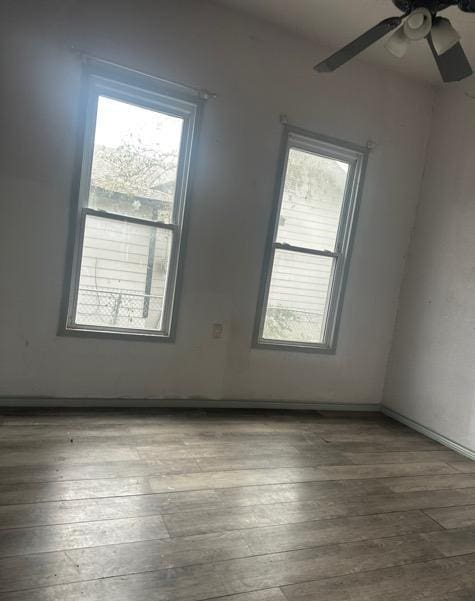 unfurnished room featuring ceiling fan and hardwood / wood-style floors