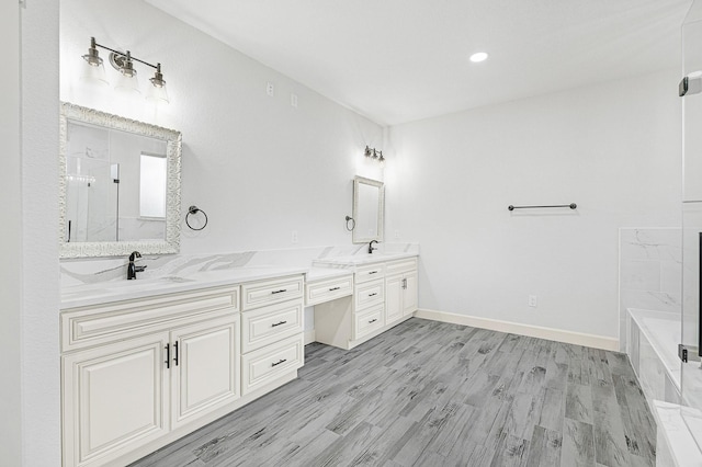 bathroom featuring vanity, independent shower and bath, and hardwood / wood-style floors