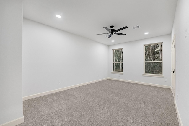 carpeted empty room featuring ceiling fan