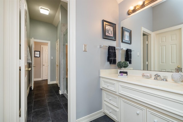 full bath featuring tile patterned floors, vanity, and baseboards