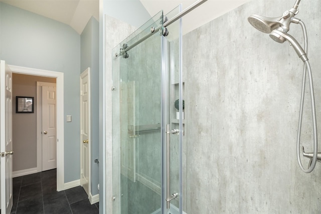 bathroom with tile patterned flooring, a shower stall, and baseboards