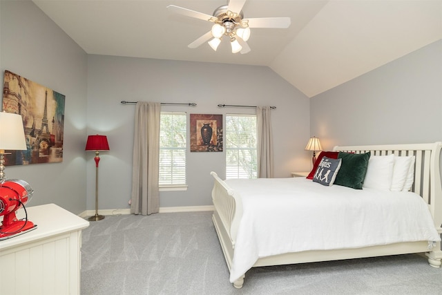 carpeted bedroom featuring lofted ceiling, baseboards, and a ceiling fan