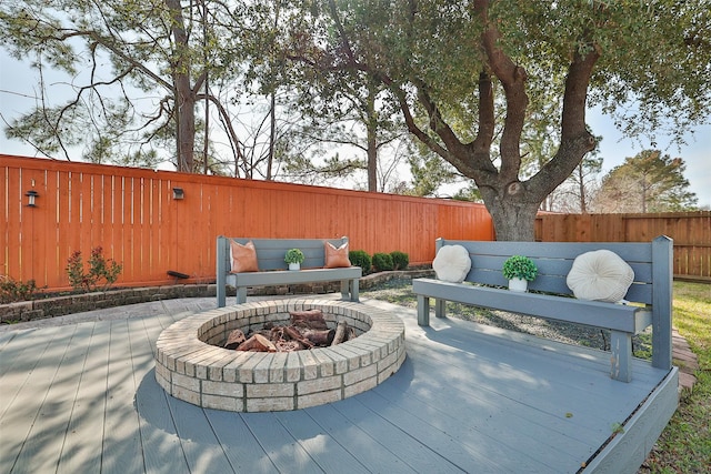 view of patio / terrace with an outdoor fire pit, a fenced backyard, and a deck