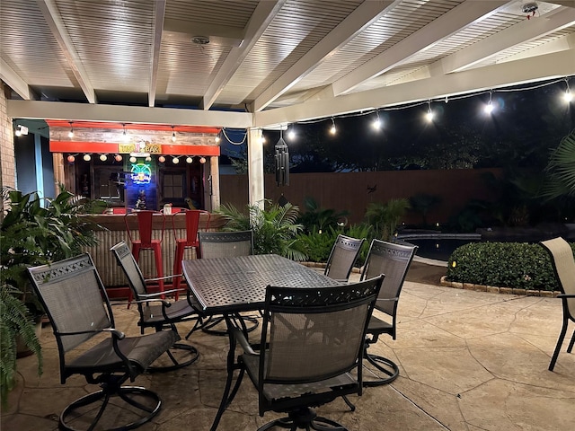 view of patio featuring outdoor dining area and fence