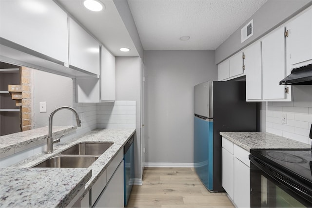 kitchen featuring appliances with stainless steel finishes, sink, white cabinets, and light stone counters