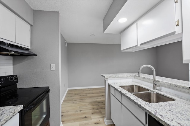 kitchen with white cabinetry, black range with electric cooktop, light stone countertops, and sink