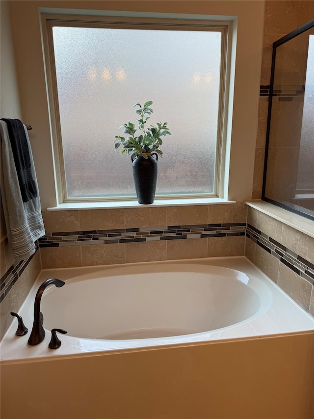 bathroom with a tub to relax in