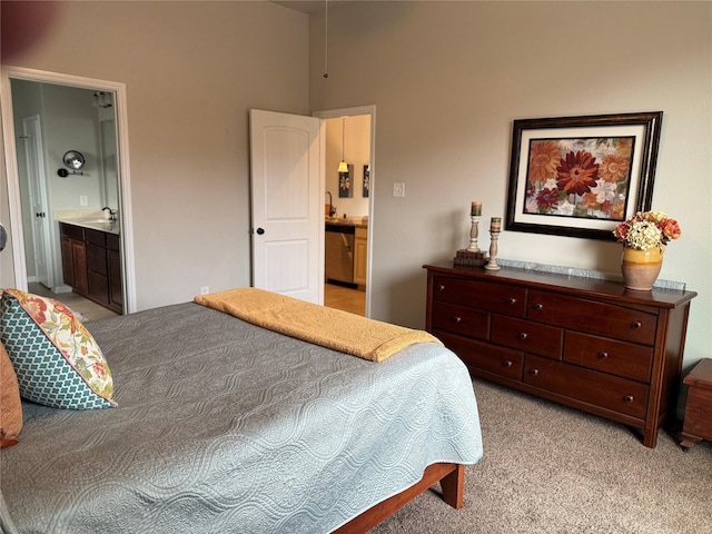 bedroom with sink, connected bathroom, and light colored carpet