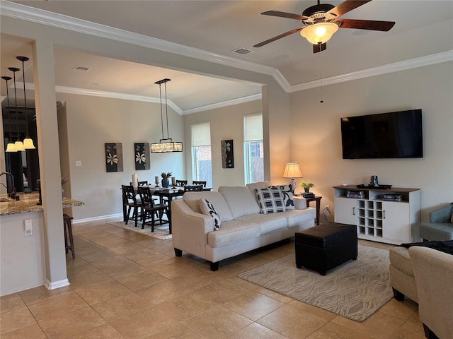 tiled living room with crown molding and ceiling fan