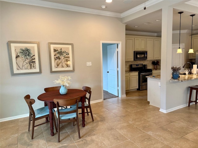 dining area with crown molding and sink