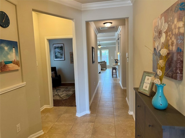 corridor featuring crown molding and light tile patterned floors