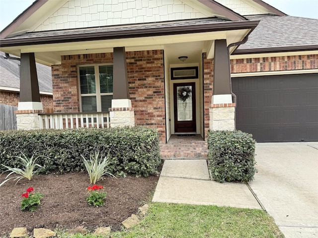 doorway to property with a porch and a garage